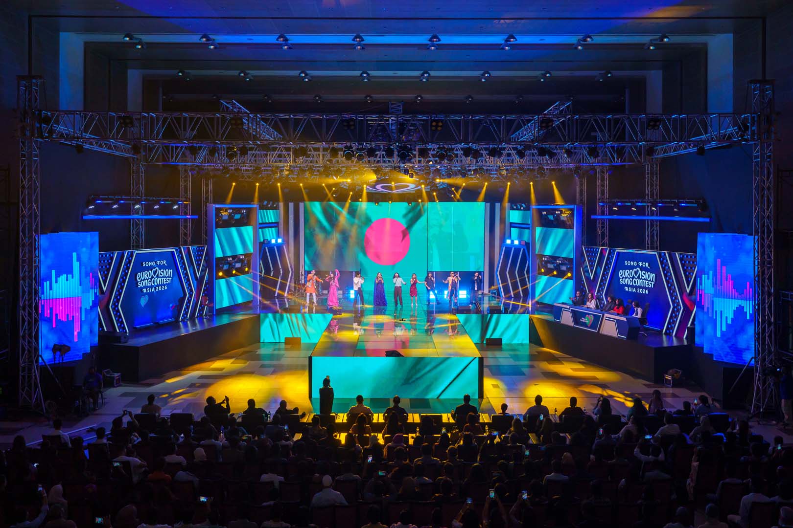 Bangladesh flag in red and green on the LED wall with the cast on stage