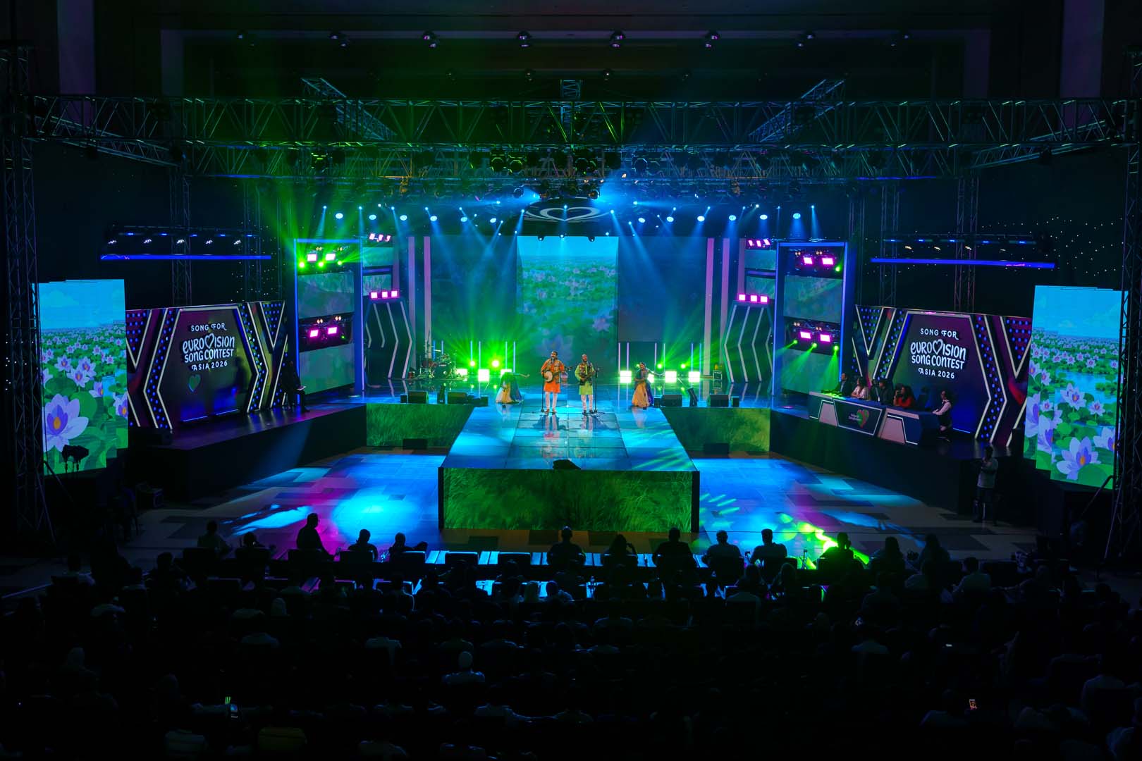 Green meadow and flower visuals on the LED wall during a Voice of Bangladesh performance